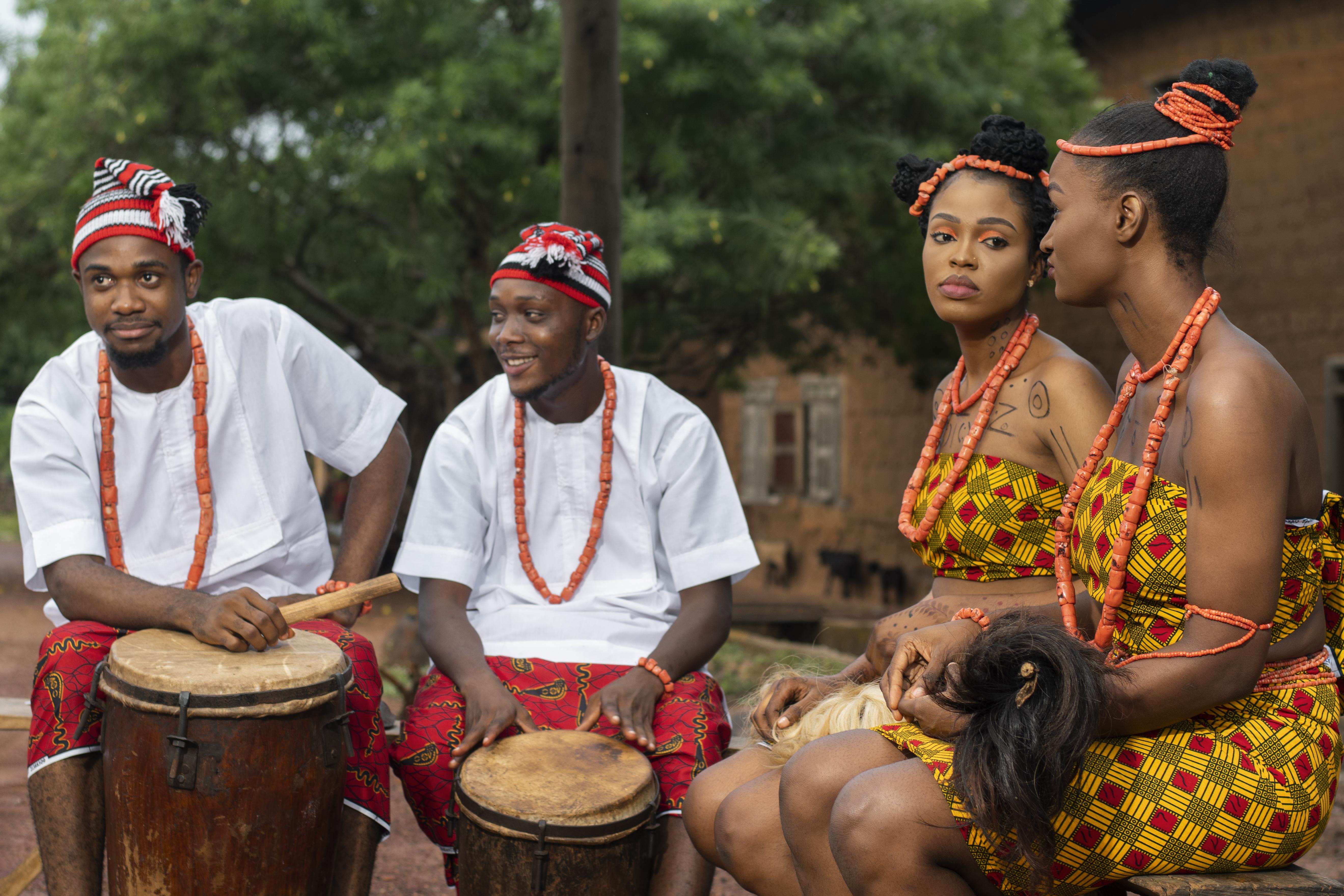 medium shot nigerian dancers with drums - Afro Tribes Canada image